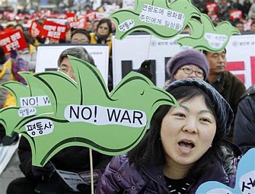 Protesters shout slogans during an anti-war and anti-government rally in Seoul