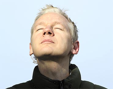 Julian Assange pauses as he speaks to the media in Norfolk, England