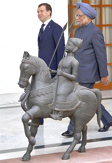 President Medvedev and PM Singh walk before their meeting in New Delhi on Tuesday