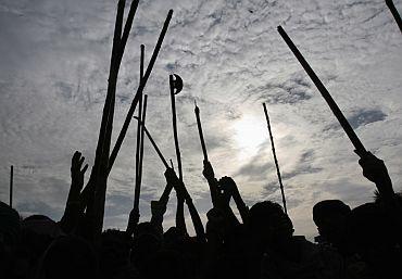 Ethnic Gujjar men shout slogans as they block a national highway during a protest in Sikandra, Rajasthan