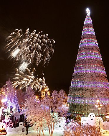 Fireworks explode around a Christmas tree during festivities in the centre of the Siberian city of Krasnoyarsk