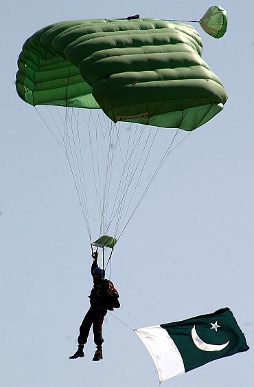 A Pakistani paratrooper from the Special Service Group (SSG) lands on the ground during a mock anti-terror exercise in Cherath.