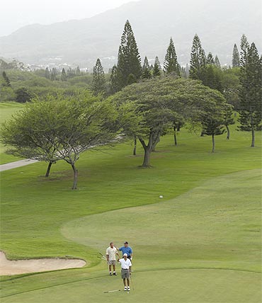 US President Barack Obama looks toward the ninth green as he plays golf at the Mid-Pacific Country Club in Kailua, Hawaii