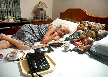 A senior, Rita Sikand sleeps in a pay for stay home in Delhi