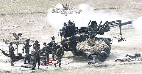Indian army soldiers fire Bofors gun during a military exercise