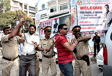 Two Sena activists being taken into custody at Vile Parle