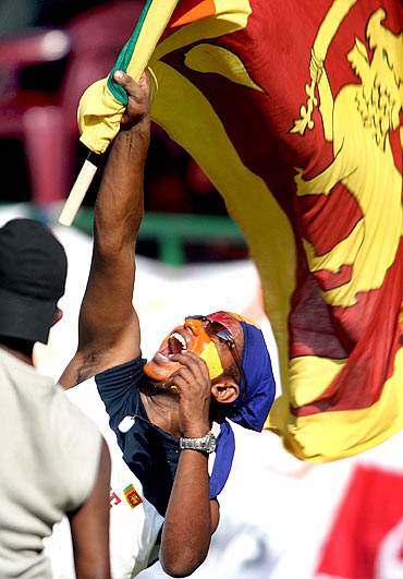 A Sri Lankan waves his country's flag