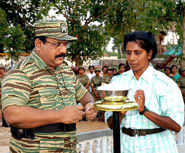 A file photo shows LTTE chief Prabhakaran lighting up a traditional lamp as he opened a new Sencholai campus, a children's home established to care for children who lost both parents in the war, in Tamil Tiger held Kilinochchi