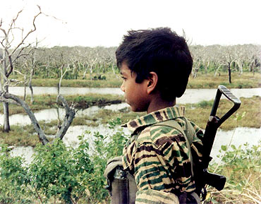 An undated picture supplied by the Sri Lankan Ministry of Defence from a collection of photographs that government soldiers said were discovered recently in a hideout in northern Sri Lanka, shows a boy dressed in LTTE uniform