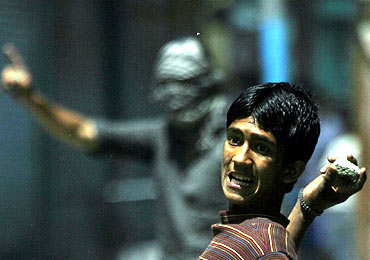 A Kashmiri protester throws a stone at police during a demonstration in Srinagar
