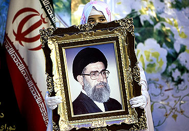 A Schoolgirl holds picture of Iran's Supreme Leader Ayatollah Khamenei