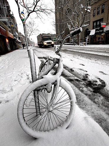 A bike is covered by snow in Brooklyn, New York