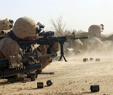 US Marines from Bravo Company of the 1st Battalion, 6th Marines, fire their weapons in the town of Marjah in Nad Ali district of Helmand province