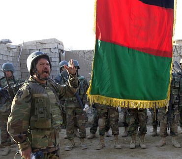 An Afghan soldier speaks during a flag raising ceremony in the town of Marjah