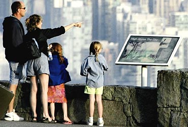 The downtown core of Vancouver, British Columbia is seen in the background as tourists take in the view from Cypress Mountain on the north shore