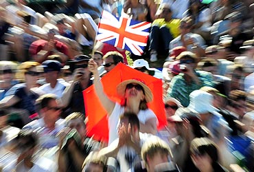A spectator waves the British flag