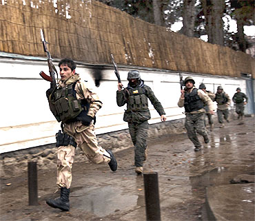 Afghan military personnel rush to the site of a fire fight with the Taliban in Kabul