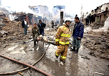 Rescue staff carry a victim from the site of the blast