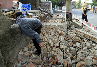 A man clears rubble after the quake in Santiago.