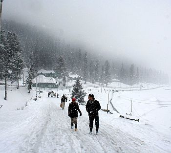 Tourists enjoy the season's second snowfall
