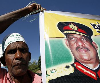 A member of the United National Party holds up a poster of former Sri Lankan army commander General Sarath Fonseka during a party convention in Colombo