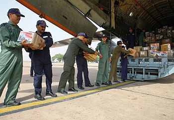 Indian Air Force personnel load relief assistance for Sri Lanka onto a transport aircraft at the airport in New Delhi