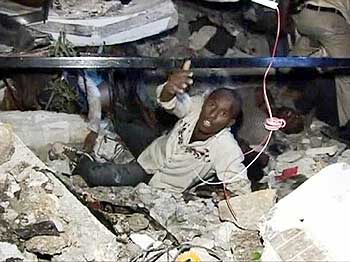 A man calls for help while being trapped among the debris at the Port-au-Prince University.