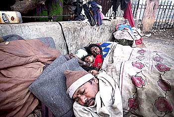 Homeless people sleep on a chilly morning in Delhi.