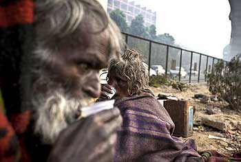 A man enjoys a cup of tea on the streets of Delhi.
