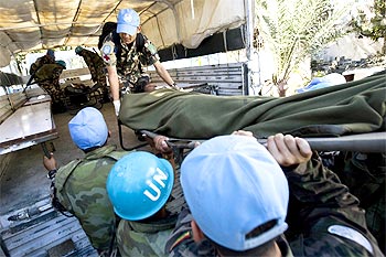 MINUSTAH (United Nations Stabilization Mission in Haiti) peacekeepers load an injured person into a truck in Port au Prince