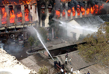 Firemen try to douse the flames at Gold Mohur Mills on Wednesday