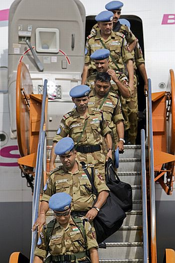 Some of the Indian officers of the Formed Police Unit leave the aircraft upon arrival at the Toussaint L'ouverture airport for deployment