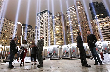 Onlookers stand inside of the 'Tribute in Lights in Manhattan' on the eighth anniversary of the attack on the World Trade Center in New York on September 11, 2009