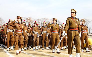 An all-woman police battalion salutes the Governor