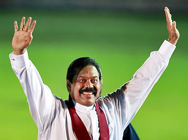 Rajapaksa waves to a crowd at his political party's convention in Colombo