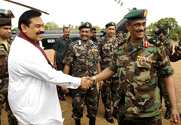 File photo shows Rajapaksa shaking hands with Army Commander Lieutenant General Sarath Fonseka