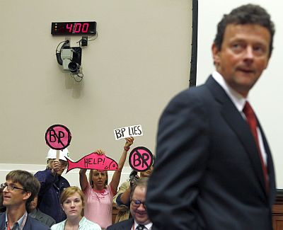 British Petroleum CEO Tony Hayward walks past protesters as he arrives to testify about the BP oil spill in the Gulf of Mexico at the House Energy and Commerce Committee on Capitol Hill on June 17, 2010.