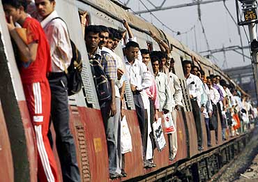 Commuters travel in a suburban train in Mumbai