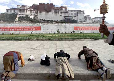 Tibetan women pray at the Potala Palace in Lhasa, Tibet