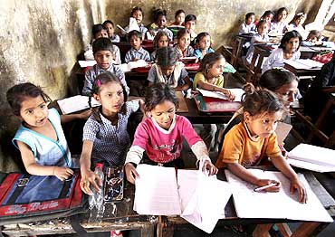 Students study in a government-run school at a slum