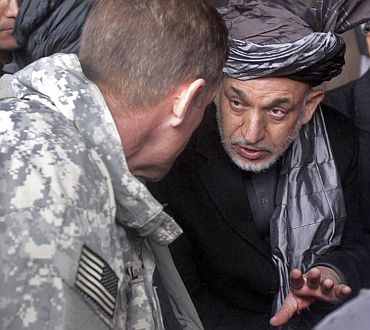 Hamid Karzai talks to then Commander of US troops in Afghanistan Gen McCrystal at Nawa district