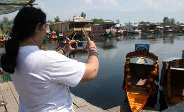 A lone tourist clicks a picture in Srinagar