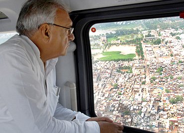 Haryana Chief Minister Bhupinder Singh Hooda surveys the flood-hit areas