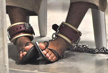 A Guantanamo detainee's feet shackled to the floor as he attends a 'Life Skills' class