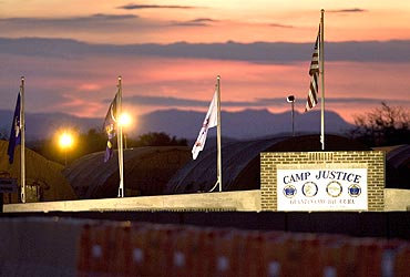 The sun sets over Camp Justice and its adjacent tent city