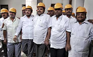 Opposition Karnataka MLAs wear helmets to the assembly to protest against the scam