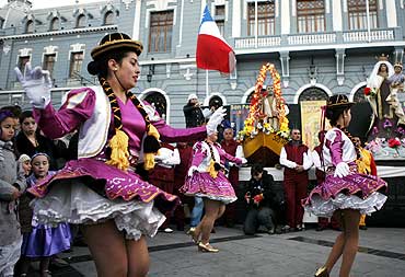 Chileans in traditional costumes dance during the annual pilgrimage of San Pedro