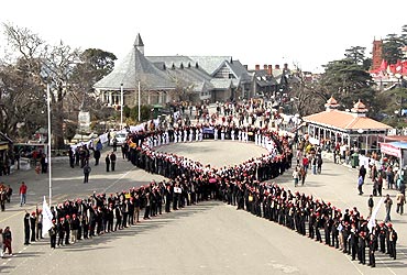 Students form the symbol of AIDS to mark World AIDS Day