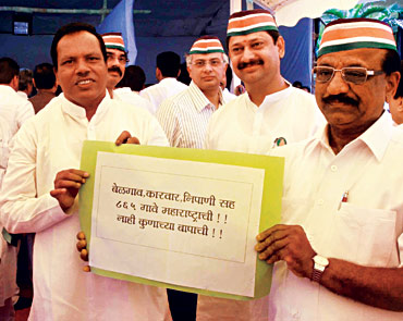 MNS legislators show a placard seeking the inclusion of 865 Marathi speaking villages