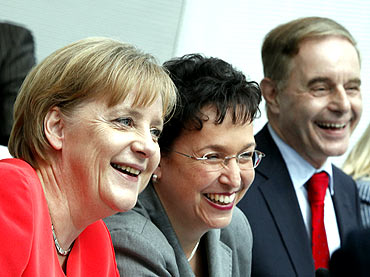 Chancellor Angela Merkel, left, with Free Democratic Party leaders Birgit Homburger, Joerg van Essen
